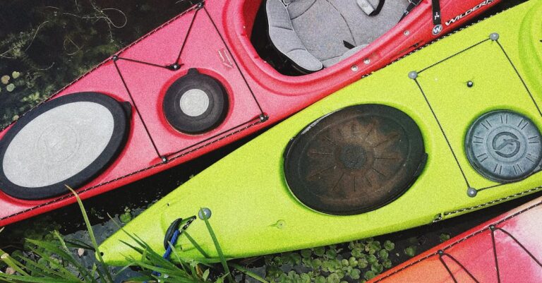 Top view of vibrant kayaks docked at a riverbank, showcasing nature and adventure in Kyiv.